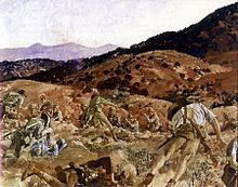 A reproduction image of a painting in which a battle scene is depicted. The terrain is rocky and undulating and men in shorts and shirts carrying rifles are falling to the ground as they are shot down from defenders standing in another trench