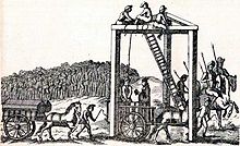A monochrome illustration of a three-legged structure, with beams connecting each leg along the top (forming an equilateral triangle, on its side).  Several men are sitting at the top of the structure, near a ladder, about 20 feet above the people below.  A rope connects the top of the structure to the neck of a man, stood on a horsecart.  Another man is reading from a book, in his direction.  Horses pull another cart, on which two coffins can be seen.  A large crowd is gathered on the horizon, watching the scene.