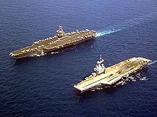 Photograph of two aircraft carriers.