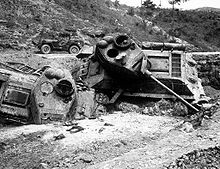 A pair of heavily damaged tanks destroyed in a ditch