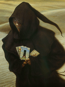Spooky looking character in a hooded gown, holding fortune cards. The background is a desert.