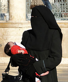 Woman wearing niqab with baby
