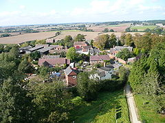 View to the north from Clifton Campville Church Spire. A "chocolate-box" image of red brick houses surrounded by fields and trees.
