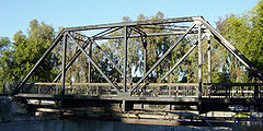 Truss bridge for a single track railway,  converted to pedestrian use and pipeline support