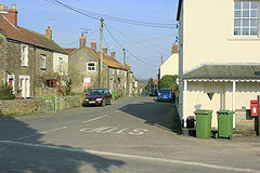 Street scene. Houses to left and right of road junction.