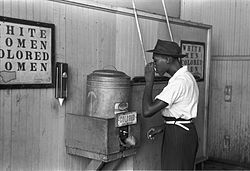 A "Colored" drinking fountain from mid-20th century with African-American drinking