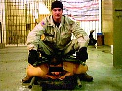 Sgt. Frederick sitting on an Iraqi POW