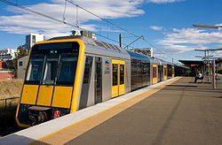 A T set Tangara in current CityRail livery with yellow front.