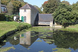 Claverton Pumping Station with the pump house on the left, the wheelhouse to the right and the millpond in the foreground