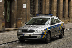 Newer-model police car, gray with blue-and-yellow markings