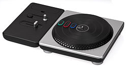 A black turntable with three buttons on the rotating deck.