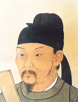 Head of a Chinese man with a goatee, a mustache, and black headwear
