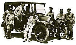 Workers at Mitsubishi Shipbuilding Co., Ltd. alongside one of the prototype Mitsubishi Model A automobiles.