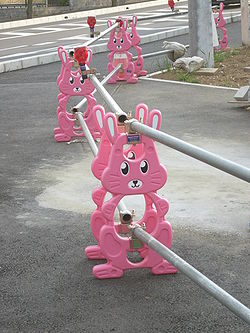 Silver roadside fence with clean, well-maintained pink bunny-shaped posts for support.