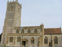 Stone building with square tower.