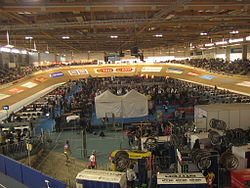 Inside the arena with bikes, cyclists and mechanics on the inside of the track