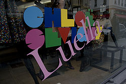A storefront window with a large slanted "Luella" superimposed over a multi-colored name logo that reads "CHLOË SEVIGNY".