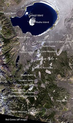 Overhead view of a large lake with three islands. Small mountains extend south. Each has a label.