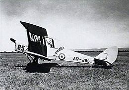 Single-engined military biplane parked on airfield