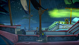 Two Age of Sail ships sail close together in rough waters off the coast of a small island in a rainstorm. A pirate on the closer ship inspects a cannon, while an undead pirate on the aftcastle of the other ship performs a magical ritual on a monkey, creating a glowing green circle in the air above them. A woman is tied up towards the front of the undead pirate's ship.