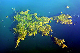 Aerial view of Sark; North is to the left of centre, Little Sark in the upper right and Brecqhou at bottom right.