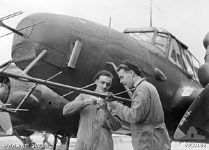 Ground crew adjust a No. 67 Squadron Avro Anson's radar in 1945