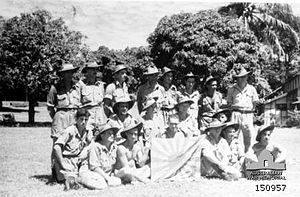 Australian soldiers with a Japanese flag captured during the fighting at at Goodenough Island