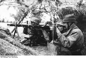 Two men in trench with gun
