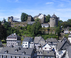 Slate-roofs of Monschau town centre and castle. The castle's courtyard in preperation for Monschau Open Air Klassik music festival