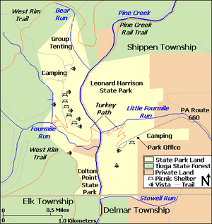 A map showing the two parks with Tioga State Forest to the north, west, and south and private land to the east. Labels include Delmar, Elk, and Shippen Townships, Pine Creek and its tributaries Bear Run, Fourmile Run, Little Fourmile Run, and Stowell Run, Pine Creek Rail Trail, West Rim Trail, Turkey Path, Pennsylvania Route 660, Park Office, and Camping and Group Tenting areas. Symbols for picnic shelters and vistas are shown in each park.