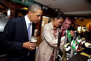 Michelle Obama pulls a pint of Guinness stout