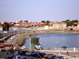 View of Nesebar's Old Town with the wooden houses, ancient ruins and churches and one of the town's symbols, the wooden windmill (to the left)