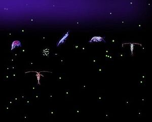 Six relatively large, variously-shaped organisms with dozens of small light-colored dots all against a dark background. Some of the organisms have antennae that are longer than their bodies.