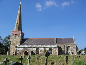 A stone church seen from the south with, from the left, a tower with a tall spire, the nave with a protruding aisle and a porch, and a shorter chancel