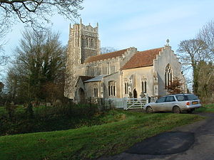 A stone church seen from the southeast with stepped gables, also showing the south chapel, porch, clerestory, and decorated tower