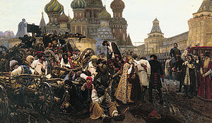 Mass of people in carts on left being taken to a barely visible background gallows in the right background while women and children look on worriedly. Wealthy aristocracy, including one on a horse, look on from the right. Multiple onion domes topping a large structure are visible in the left background.