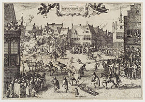 A busy urban scene. Medieval buildings surround an open space, in which several men are being dragged by horses. One man hangs from a scaffold.  A corpse is being hacked into pieces.  Another man is feeding a large cauldron with a dismembered leg.  Thousands of people line the streets and look from windows.  Children and dogs run freely.  Soldiers keep them back.