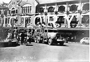 The Great Northern Railway station decorated to celebrate victory in the second world war. A large white 'VICTORY' sign is mounted atop the building's awning with the railway parade float in the front driveway