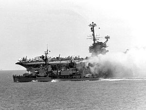 Rupertus assists in fighting fire aboard the carrier Forrestal off Vietnam