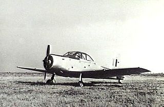 Single-engined military monoplane parked on airfield