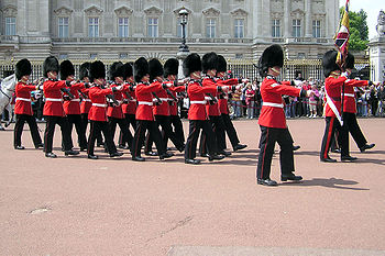 Guards march out of Buckingham Palace (London, England) at the end of the Changing of the Guard ceremony.