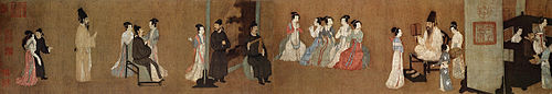 A long, landscape oriented scroll segment depicting twenty-two people, both men and women, in elegant garb at a party. Near the center of the scroll five women in light colored robes play flutes while a man in a black outfit plays a wooden intstruement composed of a stick and a triangular block. At the far right of the scroll is an area with two men and two women behind a curtain wall, staring off canvas.