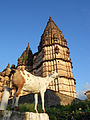 Goat with old temple in Orchha, MP, India.jpg
