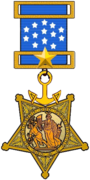 A gold star shaped military medal hanging from a blue ribbon with white five-pointed stars